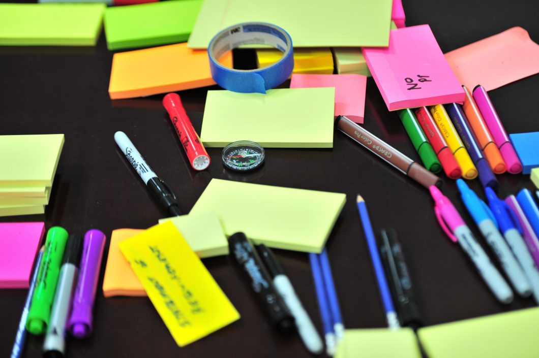 table with sticky notes and colour pens for training development