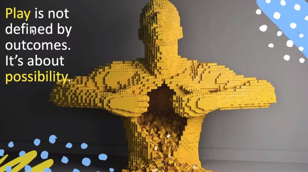 Yellow superhero made from lego opening his shirt