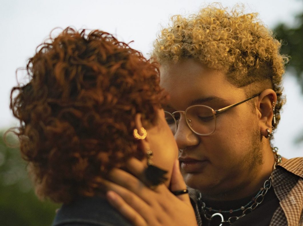 a trans couple embracing outside